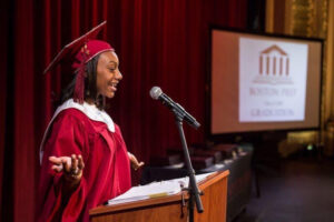 girl stands at podium during graduation ceremony