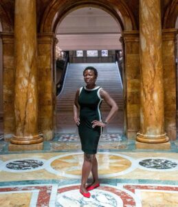 Farida stands inside the MA State House
