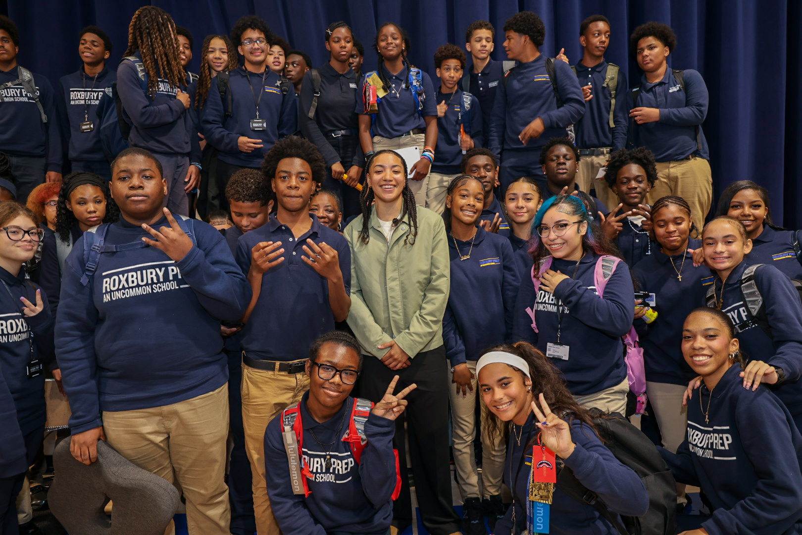 Taina Mair Surrounded by Roxbury Prep Students at WNBA Homecoming